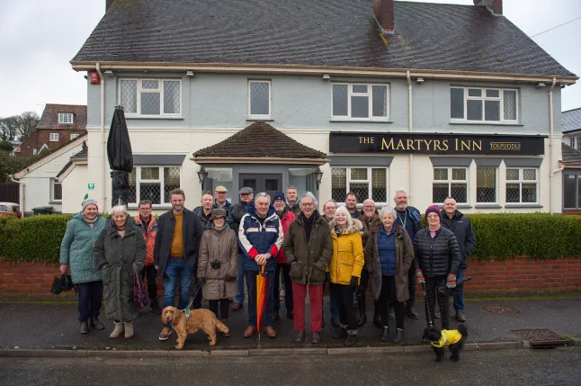 Shareholders gathered in front of The Martyrs Inn